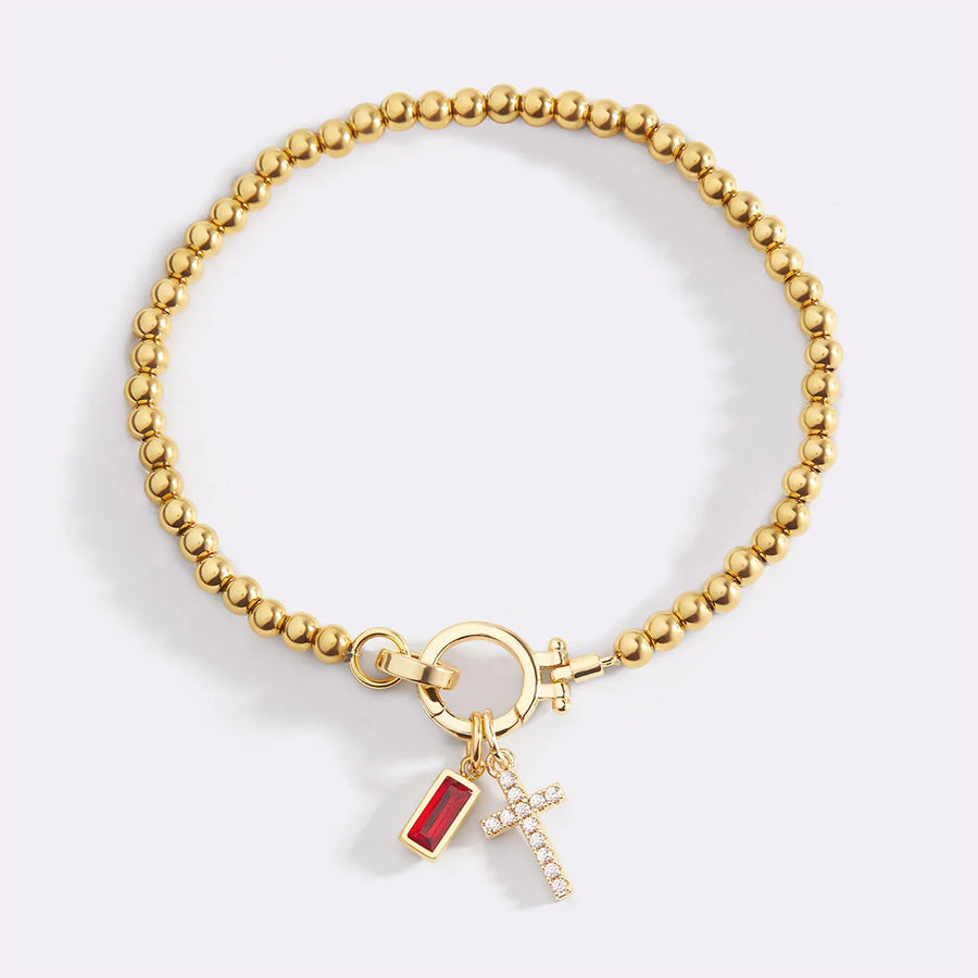 Birthstone and cross charm bracelet in gold finish